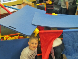 Students build forts using gym mats and Toobeez.